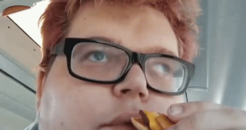 Person Wearing Glasses Eating Snack