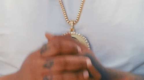 Person Wearing Gold Chain with Pendant