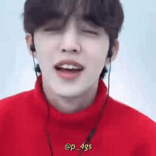 Person Wearing Headphones and Red Turtleneck