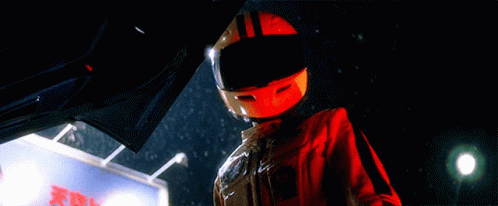 Person Wearing Helmet Next to X Sign