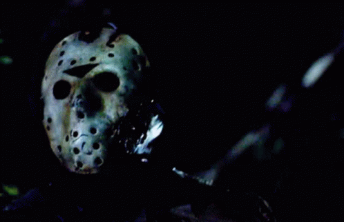 Person Wearing Jason Voorhees Helmet in Dark