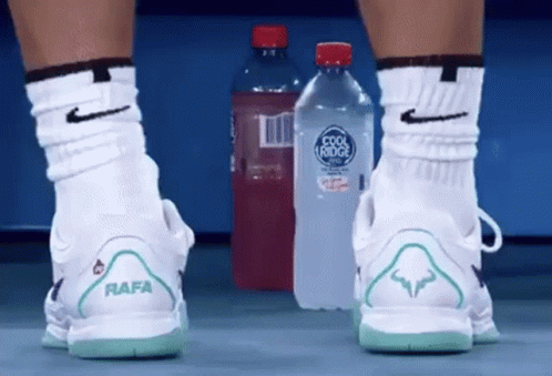 Person Wearing Nike Shoes With Rafa on Back