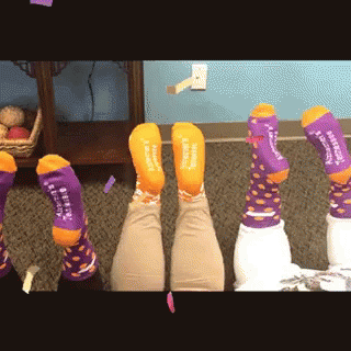 Person Wearing Purple and Orange Socks Saying I Love You
