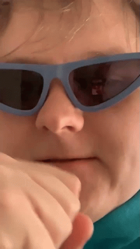 Person Wearing Sunglasses Covering Mouth GIF