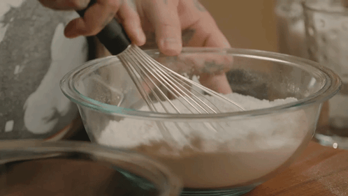 Person Whisking Flour in Bowl
