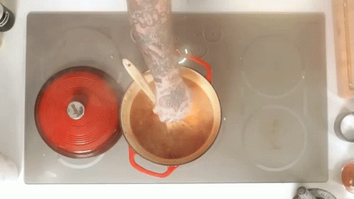 Person With Arm Tattoo Stirring Pot