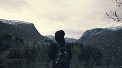 Person With Backpack In Front Of Mountain GIF