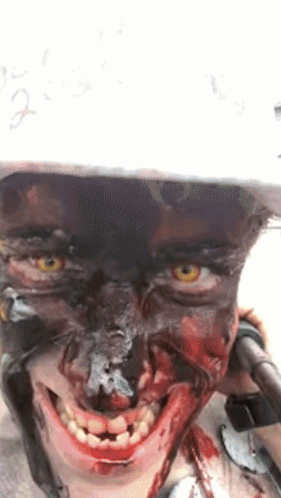 Person with Blood on Face in Helmet Smiling