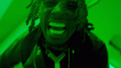 Person with Dreadlocks Screaming in Green Light