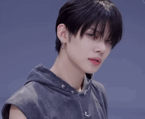 Person With Earrings and Sleeveless Hoodie