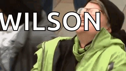 Person With Glasses in Green Jacket Wilson