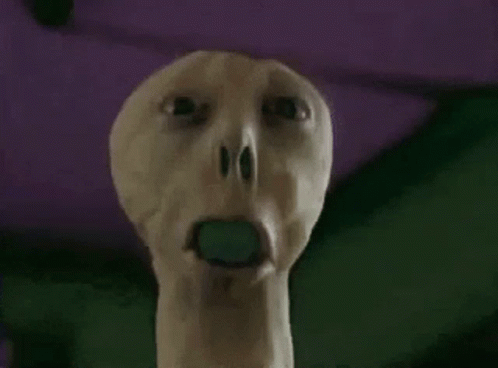 Person With Green Object in Open Mouth