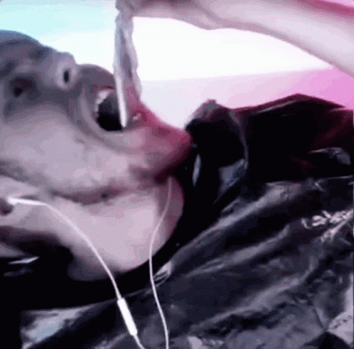 Person With Headphones Eating Meat