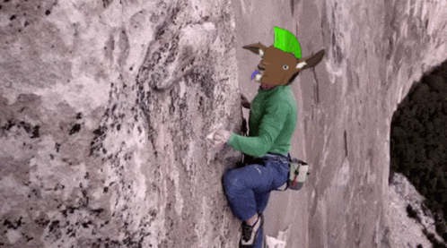 Person With Mohawk Climbing Rock Wall