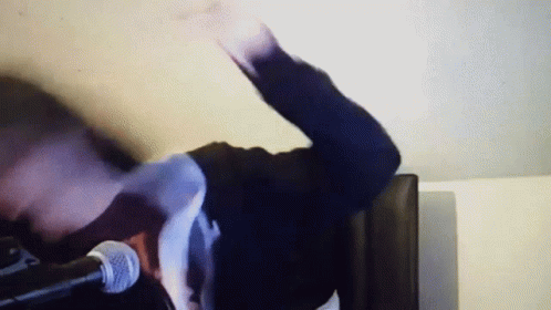 Person With Outstretched Arm At Microphone GIF
