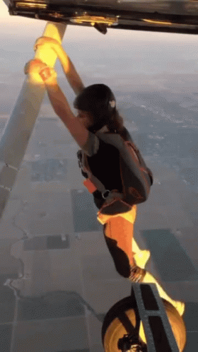 Person With Parachute Hanging From Plane