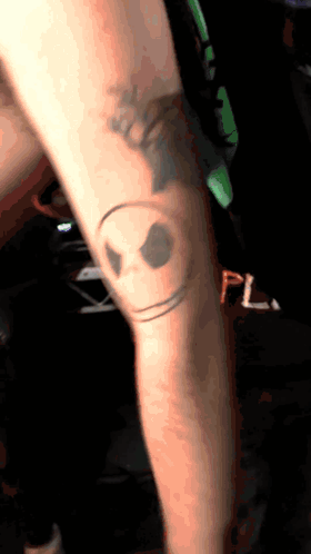 Person With Smiley Face Knee Tattoo