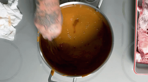 Person With Tattoo Stirring Pot