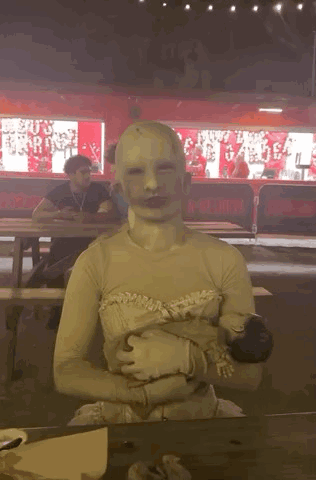 Person With White Mask Sitting at Table