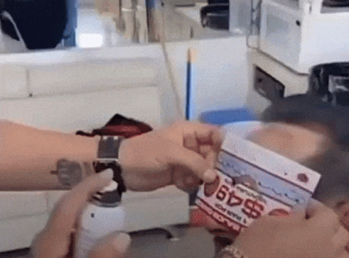 Person With Wrist Tattoo Holding Box Saying $49 GIF