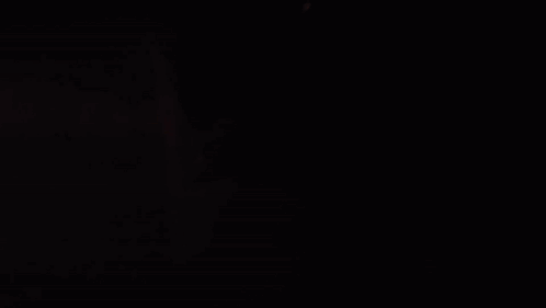 Person Writing on Paper in Dark