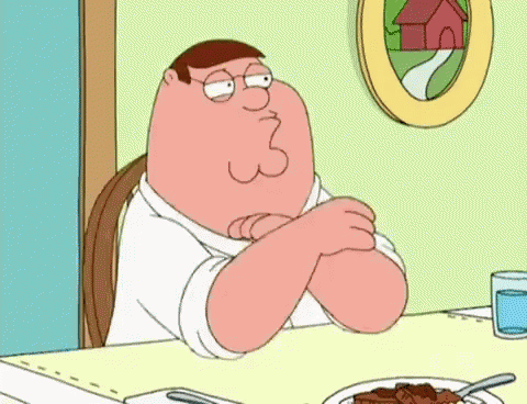 Peter Griffin Is Sitting At A Table With His Arms Crossed GIF