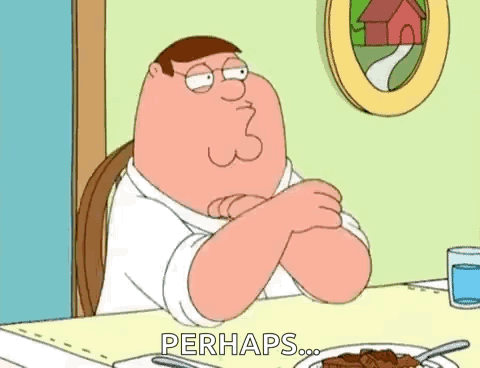 Peter Griffin Is Sitting At A Table With His Arms Crossed . GIF