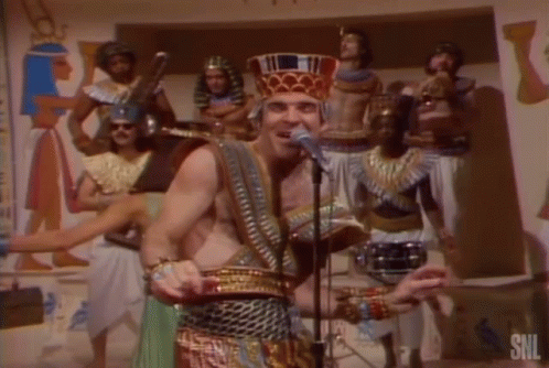 Pharaoh Costume Man Singing into Microphone