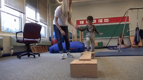 Physical Therapist With A Young Patient GIF