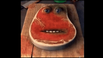 Piece of Meat With Face on Cutting Board