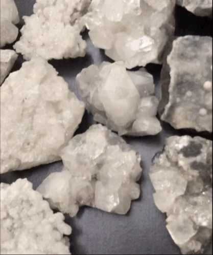 Pile Of White Rocks On Black Background GIF
