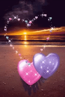 Pink And Purple Hearts On A Beach With Hearts Coming Out Of Them GIF