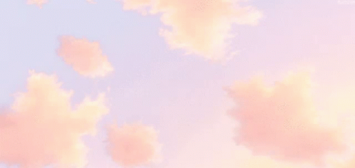 Pink Clouds In A Blue Sky With A Few Trees In The Background GIF