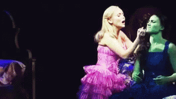 Pink Dress Woman Next To Blue Dress Woman GIF