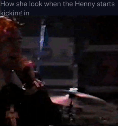 Pink-Haired Man At Microphone In Dark Room GIF