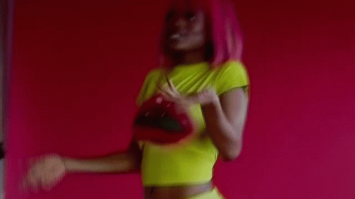 Pink-Haired Woman In Yellow Crop Top Holding Red Purse GIF