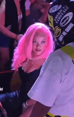 Pink-Haired Woman Next To Man In Black Shirt GIF