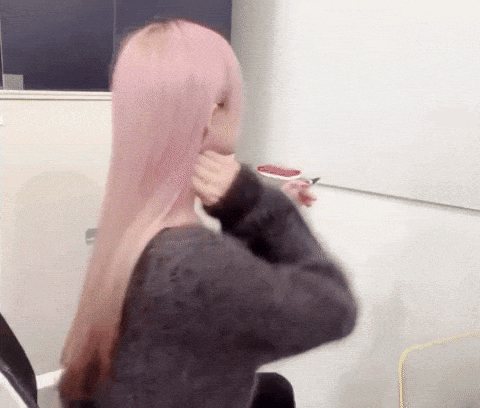 Pink-Haired Woman Sitting at Mirror