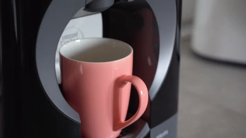 Pink Nescafe Cup Being Poured Into Krups Coffee Maker