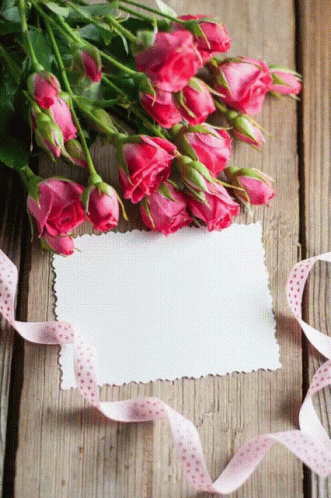 Pink Roses on Wooden Table With Card