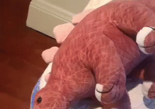 Pink Stuffed Dinosaur Laying On White Plate GIF