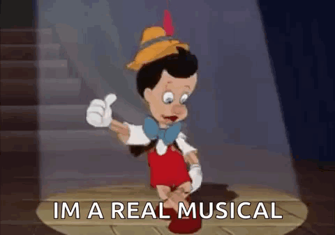 Pinocchio Is Giving A Thumbs Up And Saying `` I 'M A Real Musical '' While Standing On A Stage . GIF