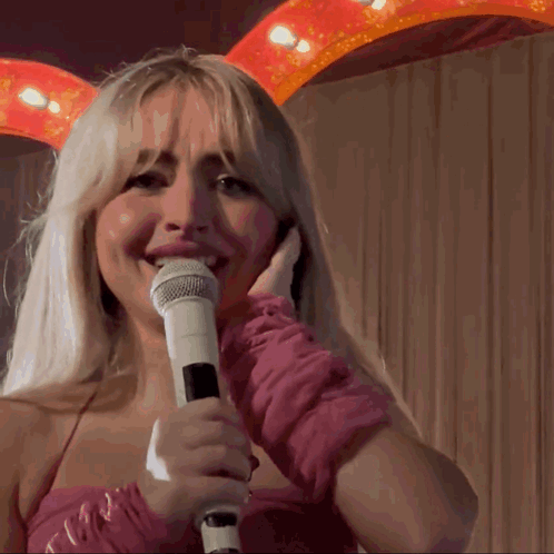 Pixelated Woman Holding Microphone Covering Mouth