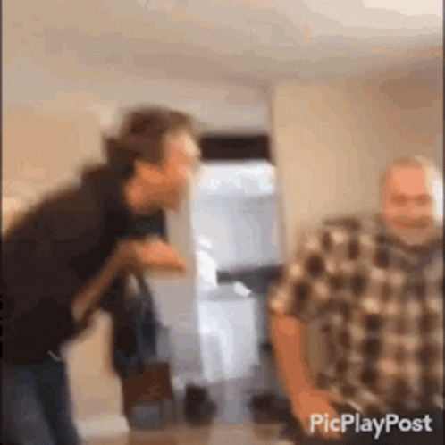 Plaid Shirt Man Standing Next To Another Man GIF