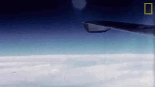 Plane Flying Through Clouds With National Geographic Logo GIF