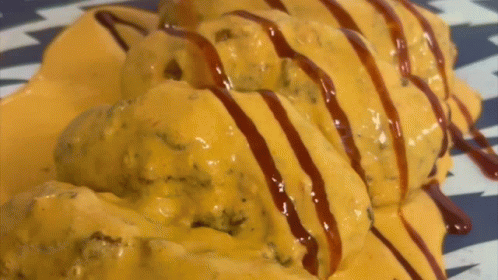 Plate Of Food Covered In Cheese And Sauce GIF