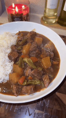 Plate Of Stew With Rice And Candle GIF