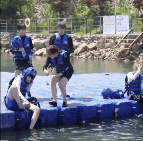Playful Friends Pushed In Water GIF