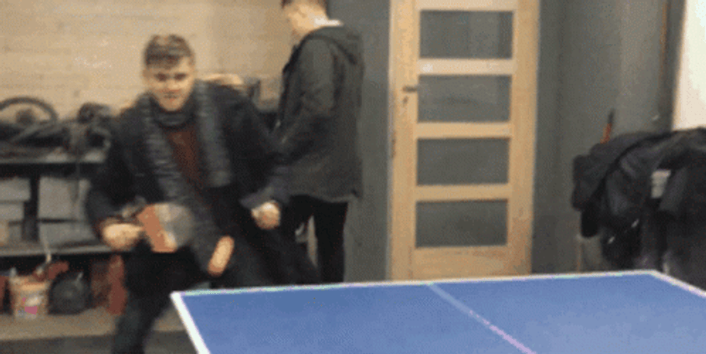 Playing Ping Pong Wearing Winter Outfit GIF