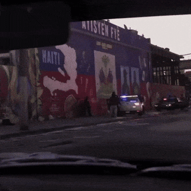Police Car Parked In Front Of Ten Fye Building GIF